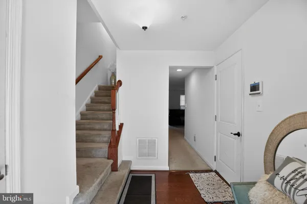 a view of entryway with furniture and wooden floor
