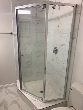 a bathroom with a glass door shower