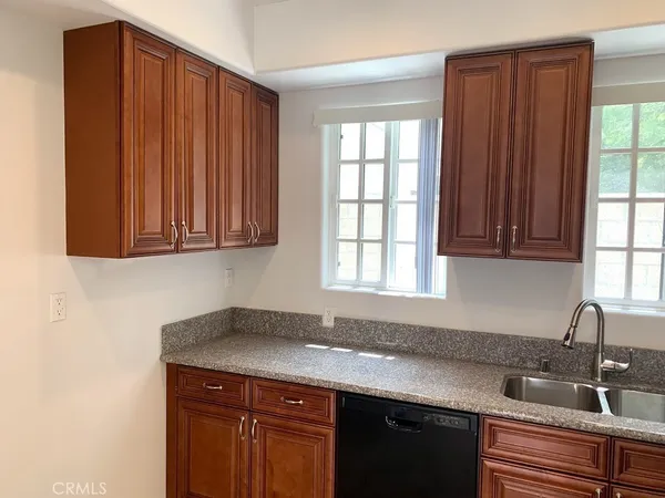 a kitchen with a sink cabinets and window