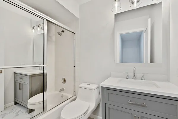 a bathroom with a sink toilet and shower