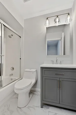 a bathroom with a toilet sink and shower