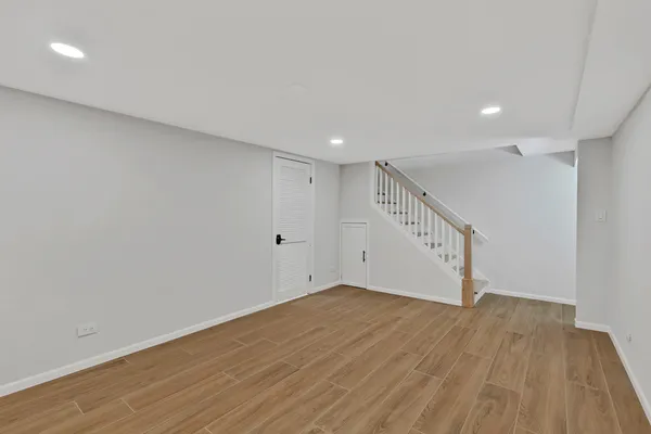 a view of an empty room with wooden floor