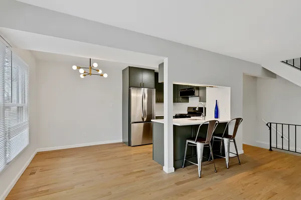 a view of a dining room with furniture and wooden floor