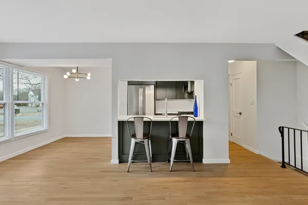 a dining room with furniture and wooden floor