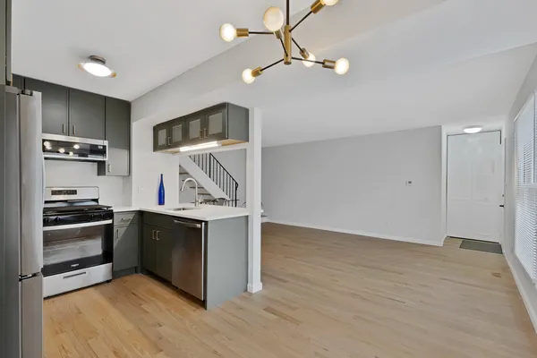 a view of kitchen with sink and stainless steel appliances