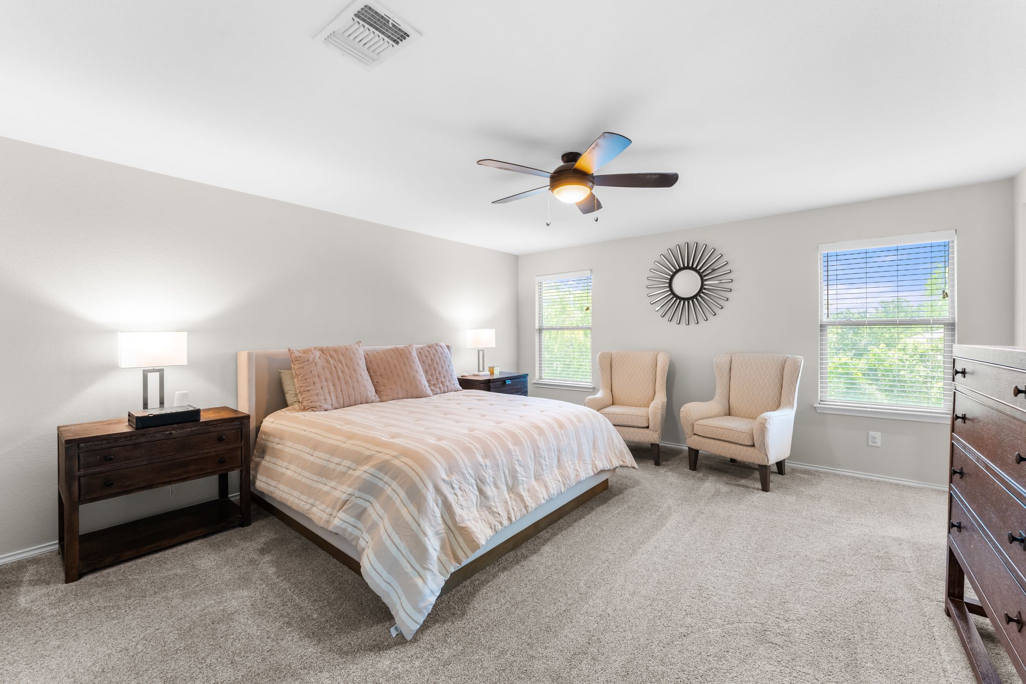1133 Yellow Iris Road Leander, TX 78641 - Photo 22 of 37 Spacious room with plush carpet flooring, multiple windows, a ceiling fan with integrated lighting, and neutral wall tones