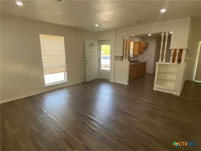 a view of a kitchen with a sink and a refrigerator
