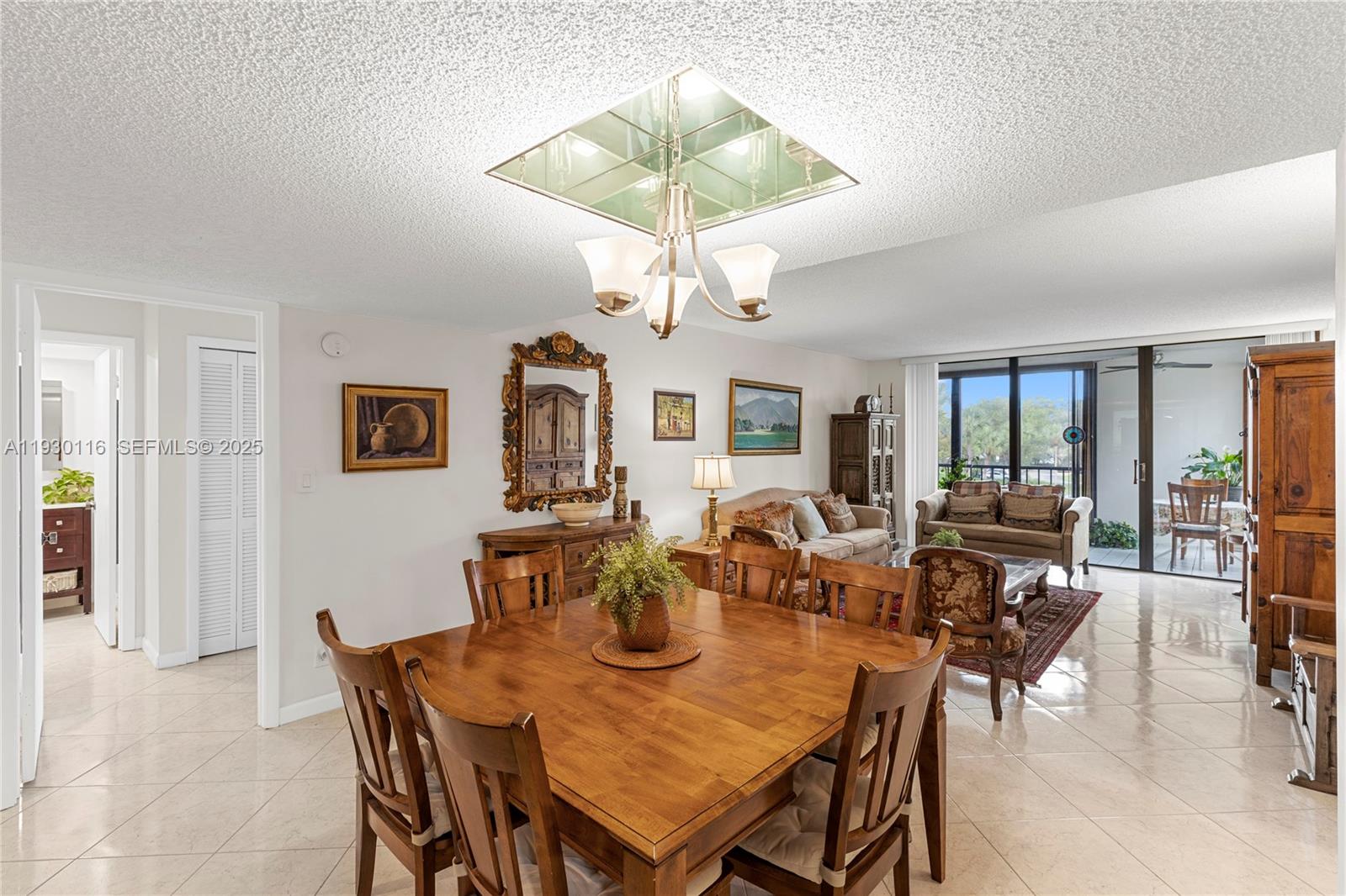 a view of a dining room with furniture and chandelier