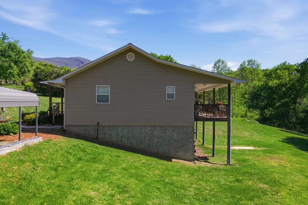 68 West Vineyard Road Hayesville, NC 28904 - Photo 15 of 46 a backyard of a house with plants and wooden fence