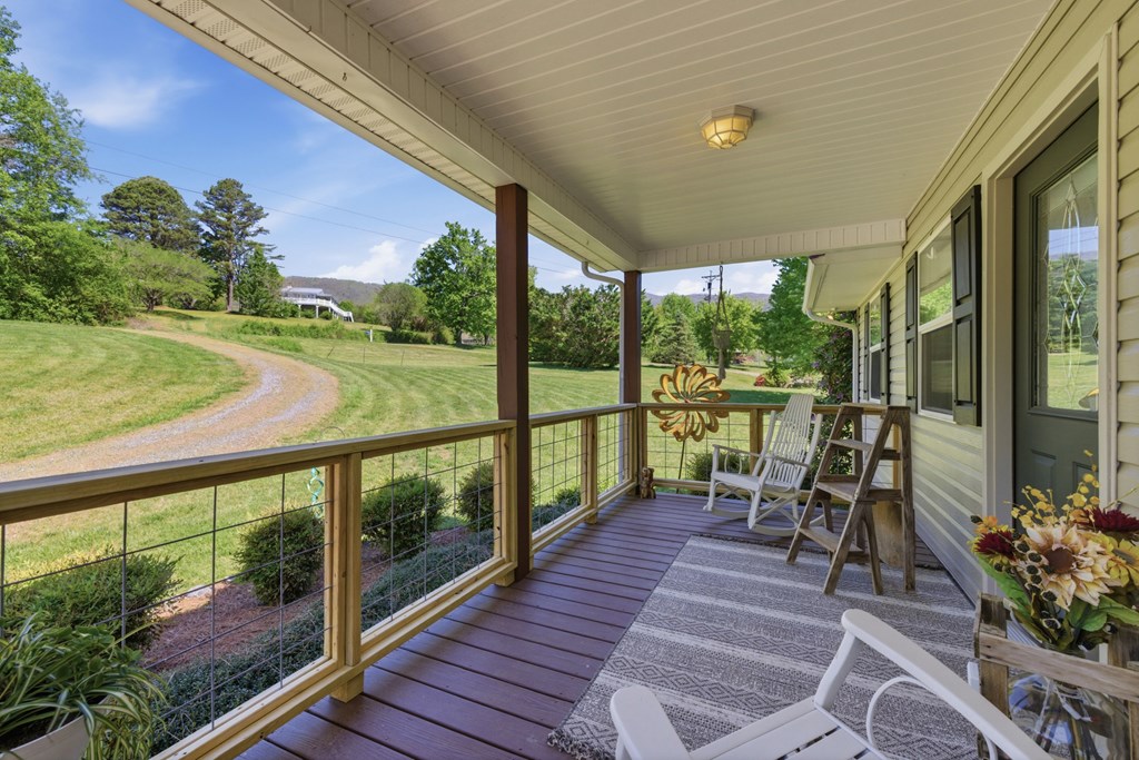 68 West Vineyard Road Hayesville, NC 28904 - Photo 19 of 46 a view of a balcony with chairs and wooden floor