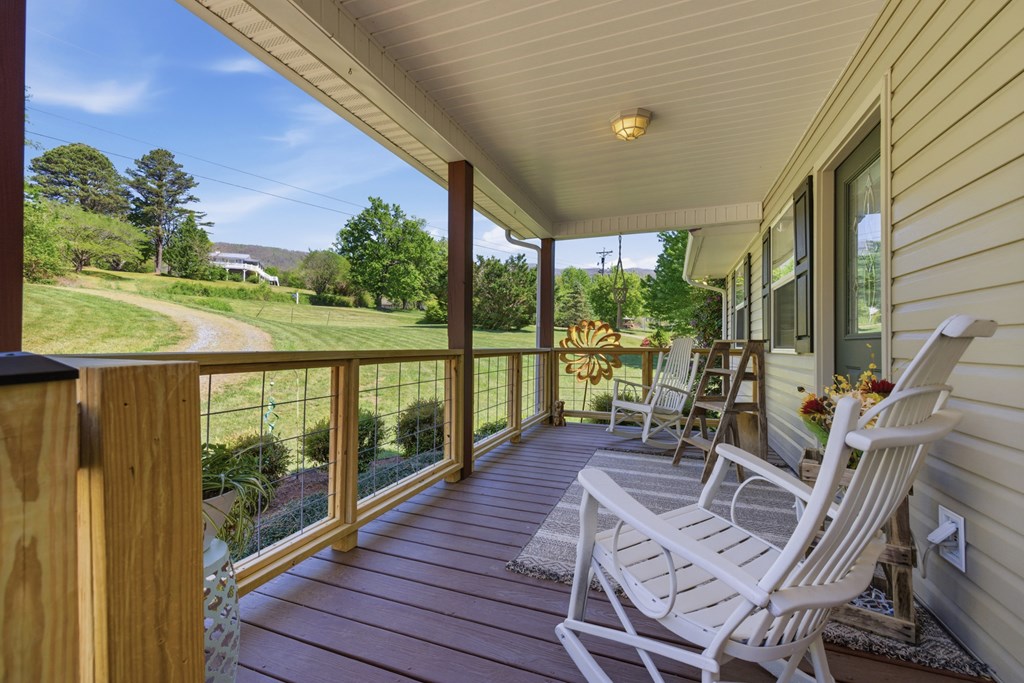 68 West Vineyard Road Hayesville, NC 28904 - Photo 20 of 46 a view of a balcony with chairs and a table
