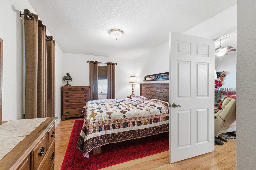 68 West Vineyard Road Hayesville, NC 28904 - Photo 30 of 46 a bedroom with a bed and a dresser