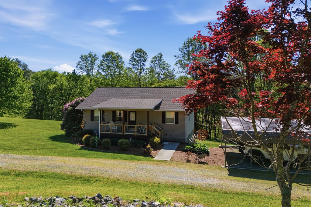 68 West Vineyard Road Hayesville, NC 28904 - Photo 3 of 46 a view of a house with backyard sitting area and garden