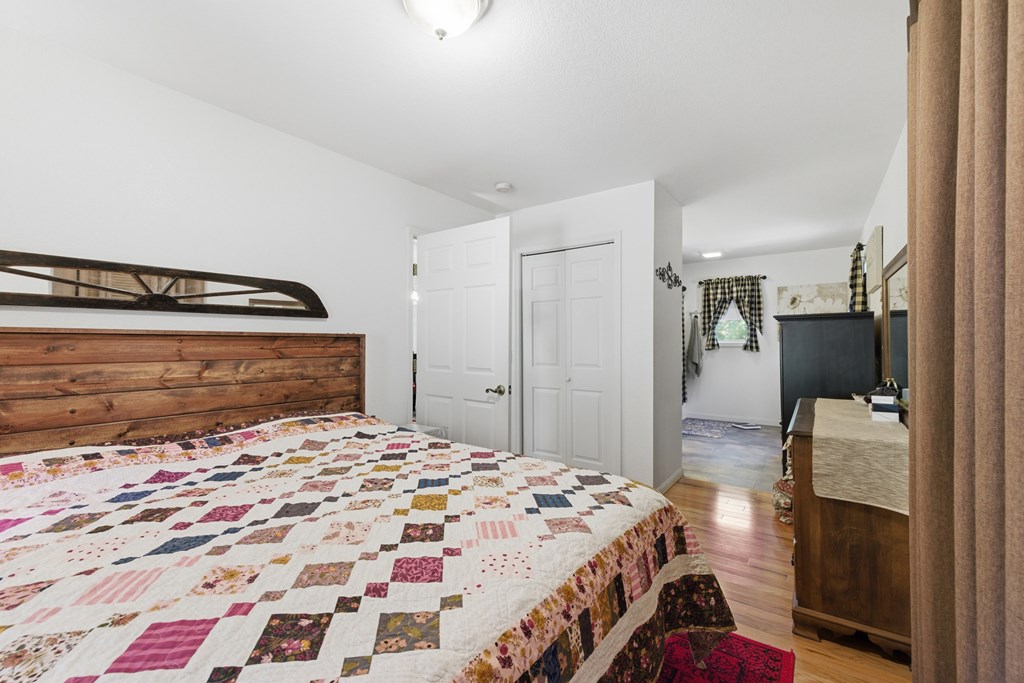 68 West Vineyard Road Hayesville, NC 28904 - Photo 31 of 46 a bedroom with a bed and a mirror