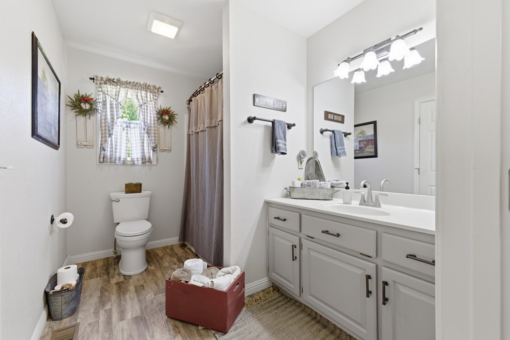 68 West Vineyard Road Hayesville, NC 28904 - Photo 34 of 46 a bathroom with a toilet sink and mirror
