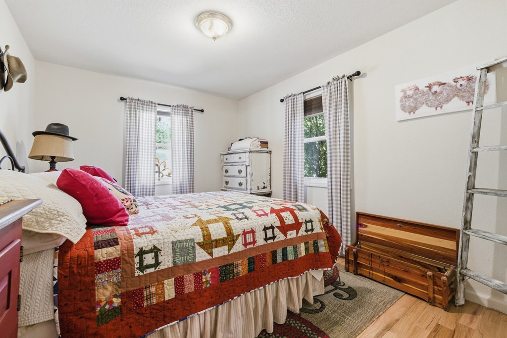 68 West Vineyard Road Hayesville, NC 28904 - Photo 35 of 46 a bedroom with a bed and wooden floor