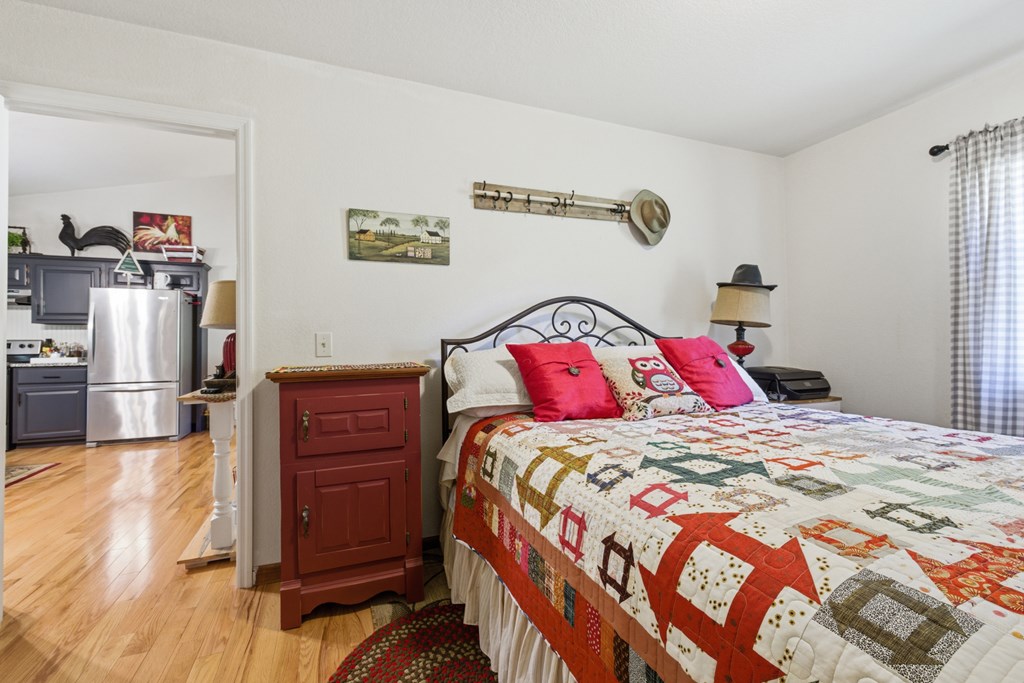 68 West Vineyard Road Hayesville, NC 28904 - Photo 36 of 46 a bedroom with a bed and a refrigerator