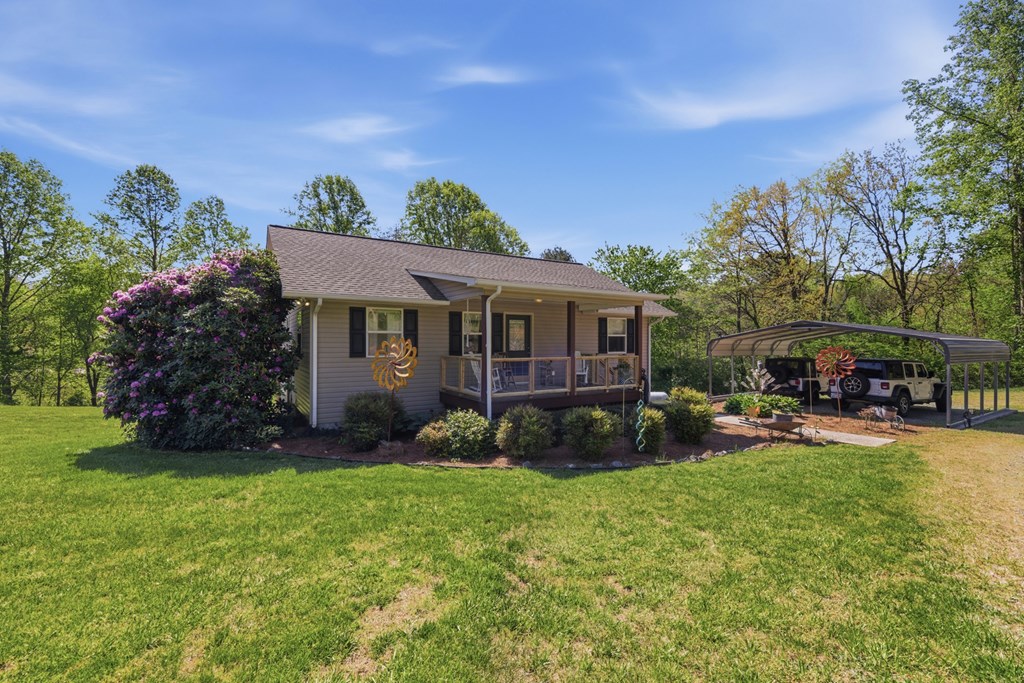 68 West Vineyard Road Hayesville, NC 28904 - Photo 6 of 46 a view of a house with a yard and sitting area