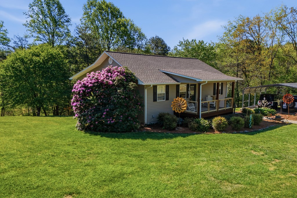 68 West Vineyard Road Hayesville, NC 28904 - Photo 10 of 46 a view of a house with a garden and plants