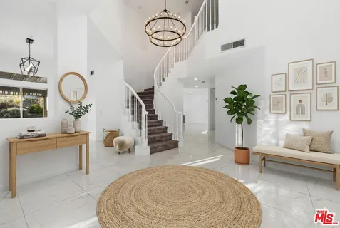 a view of a kitchen with white walls