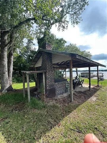 a backyard of a house with a swing table and chairs