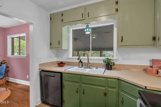 a kitchen with a refrigerator sink and cabinets