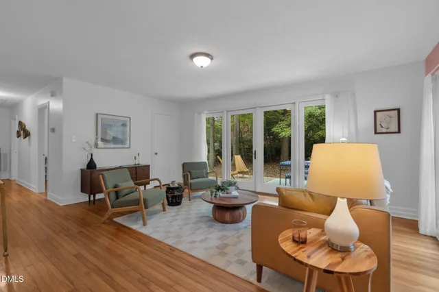 a living room with furniture and a floor to ceiling window