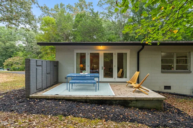 a view of a patio with a table and chairs
