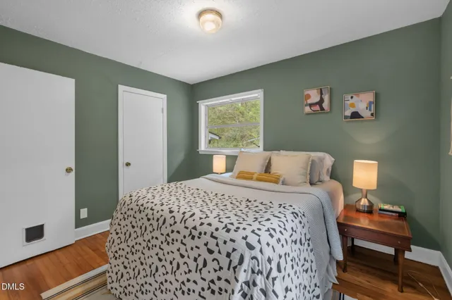 a bedroom with a bed and wooden floor