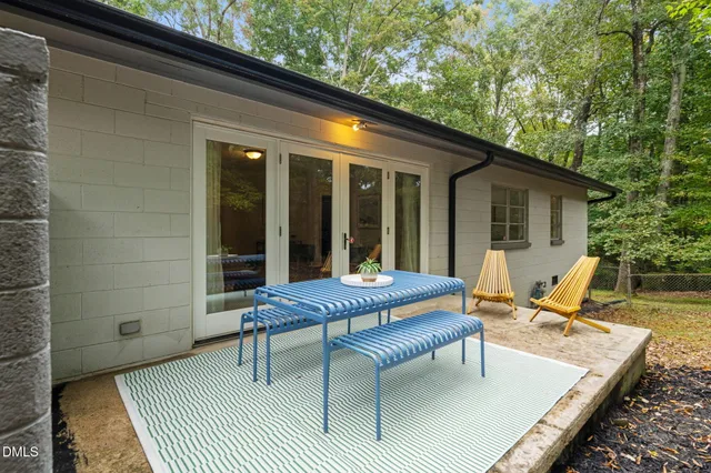 a view of backyard with a patio and outdoor seating