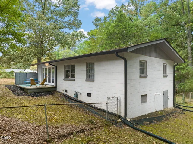 a white house that has tree in front of it
