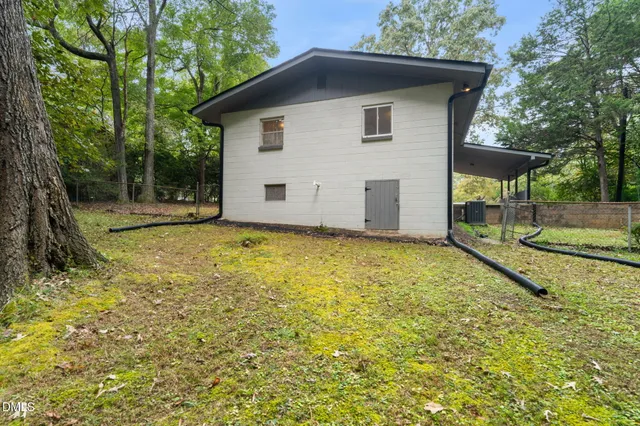 a white house that has tree in front of it