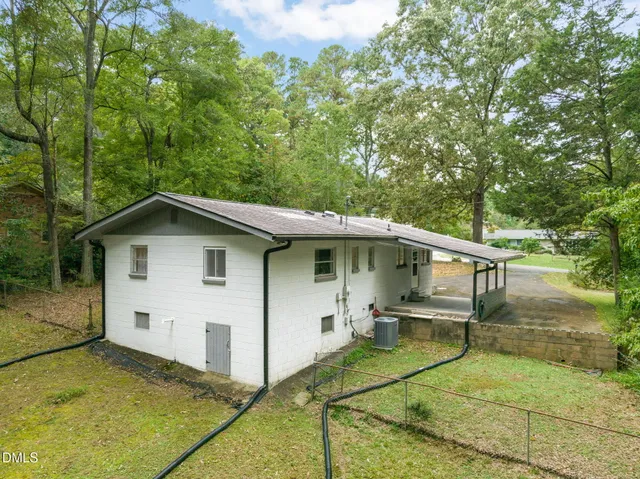 a view of a house with a backyard and a garden