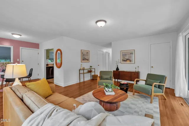 a living room with furniture and a table