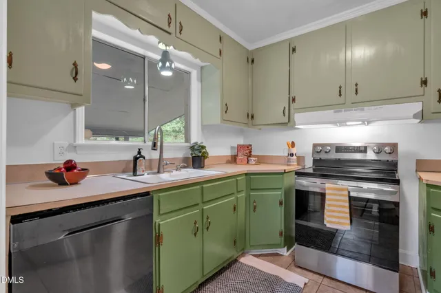 a kitchen with a sink cabinets and stainless steel appliances