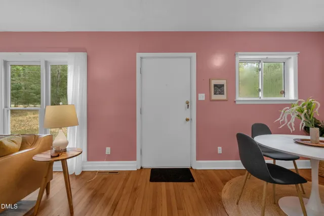 a view of a dining room with furniture and wooden floor