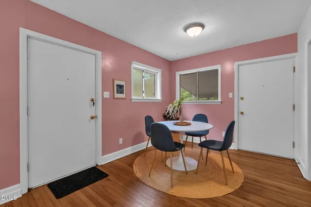 a dining room with furniture and wooden floor