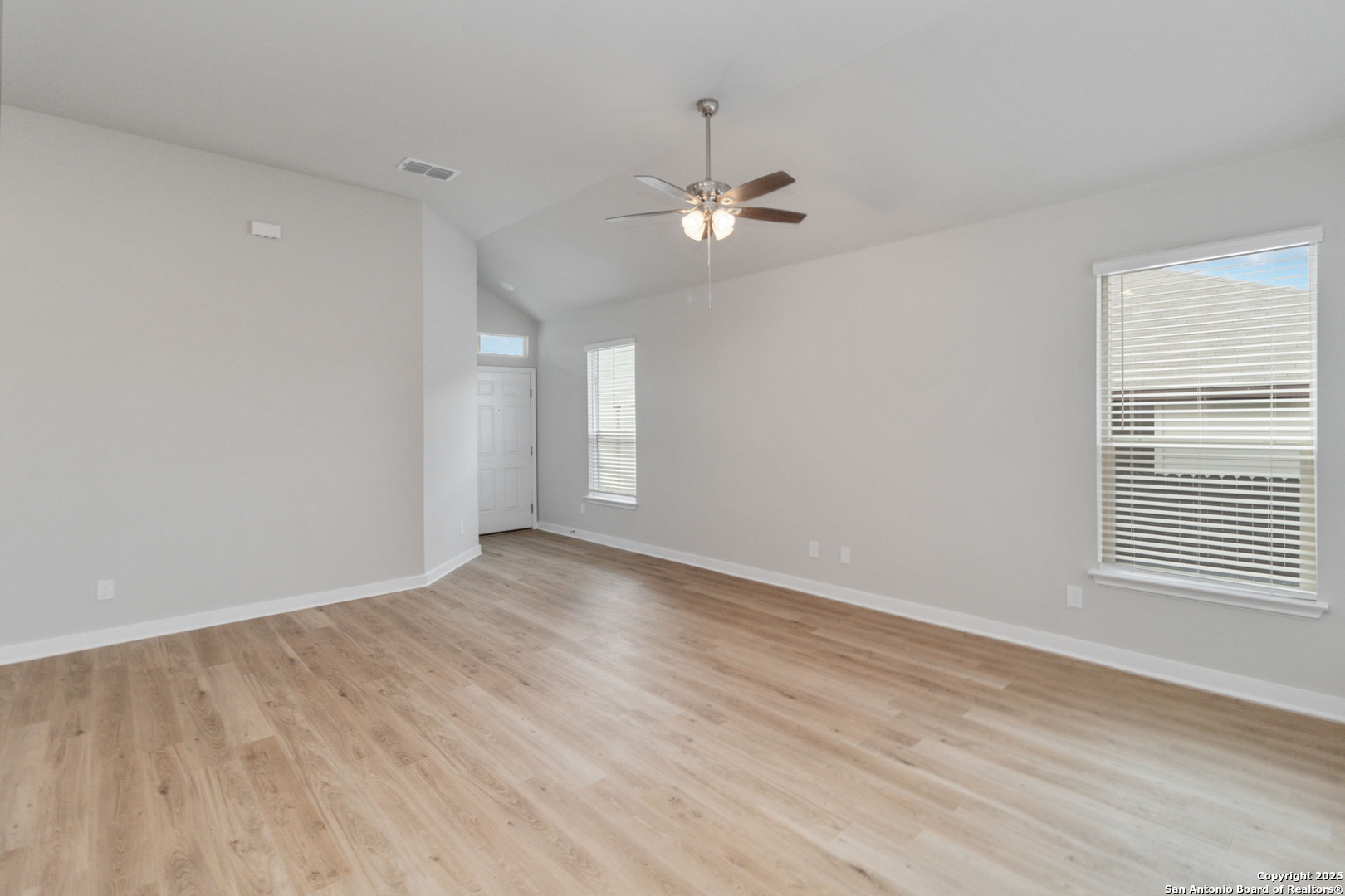 415 Cross Barn Boulevard, Unit B Buda, TX 78610 - Photo 11 of 23 wooden floor in an empty room with a window