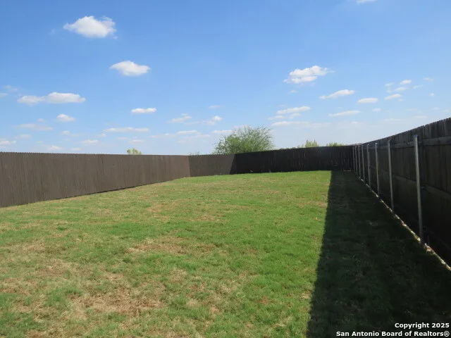 a view of yard with swimming pool and outdoor seating