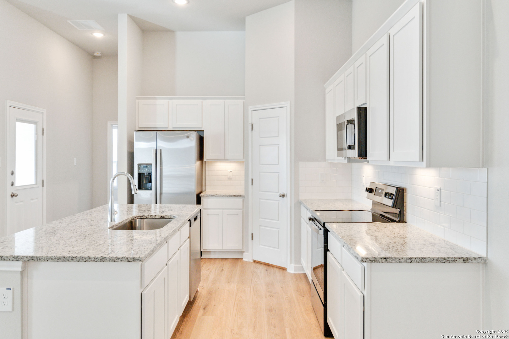 415 Cross Barn Boulevard, Unit B Buda, TX 78610 - Photo 10 of 23 a kitchen with granite countertop a sink and cabinets