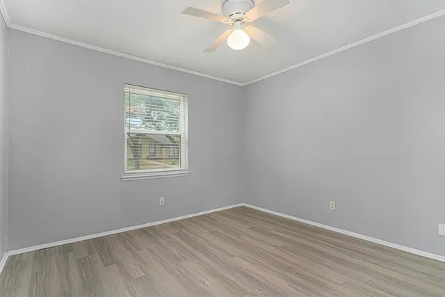 wooden floor in an empty room with a window