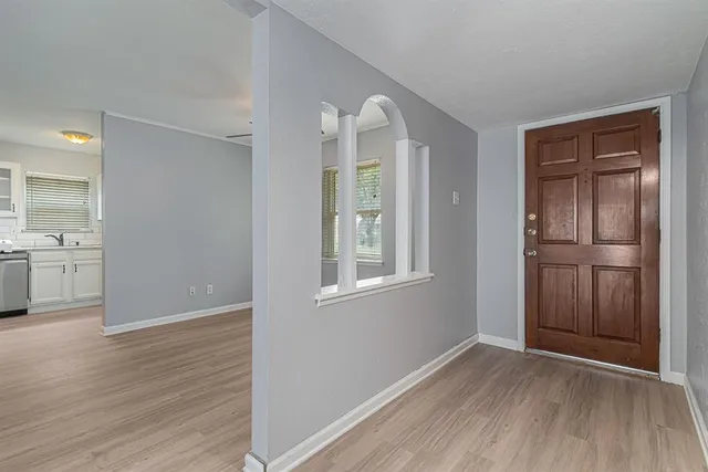 an empty room with closet and windows