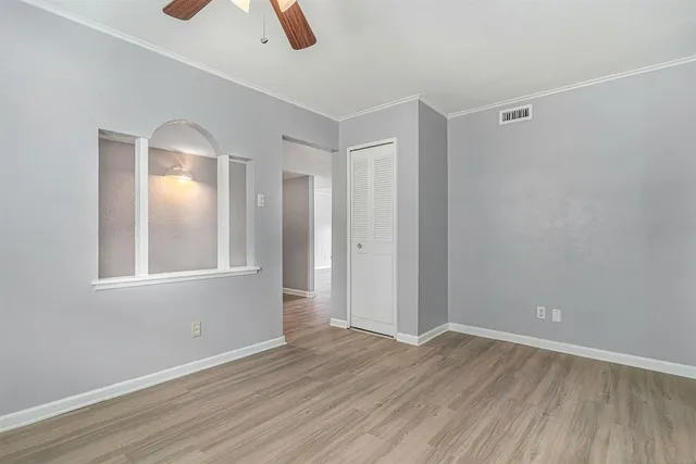 wooden floor in an empty room with a window