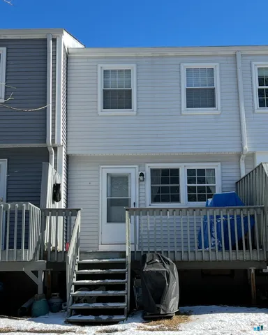 a view of a house with wooden deck