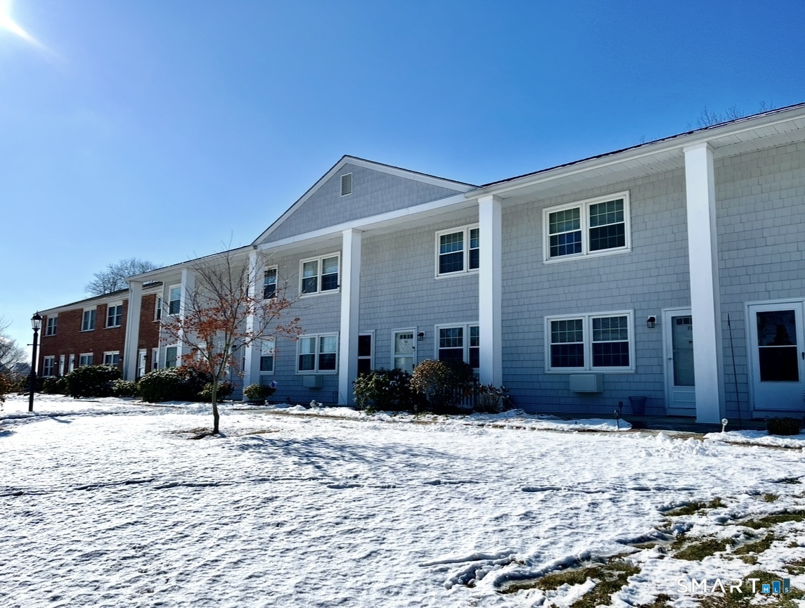 25 Riverside Drive, Unit E4 Clinton, CT 06413 - Photo 10 of 14 a front view of a house with a yard