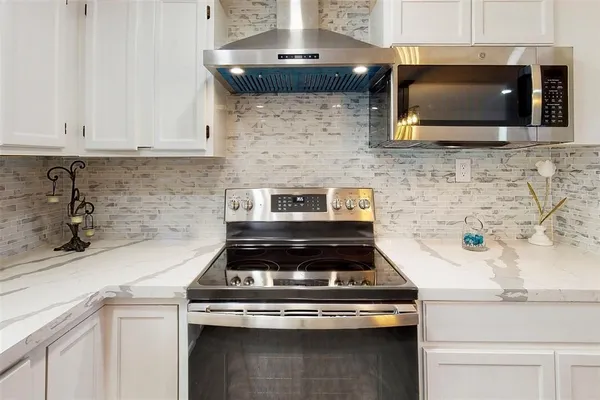 a stove top oven sitting inside of a kitchen
