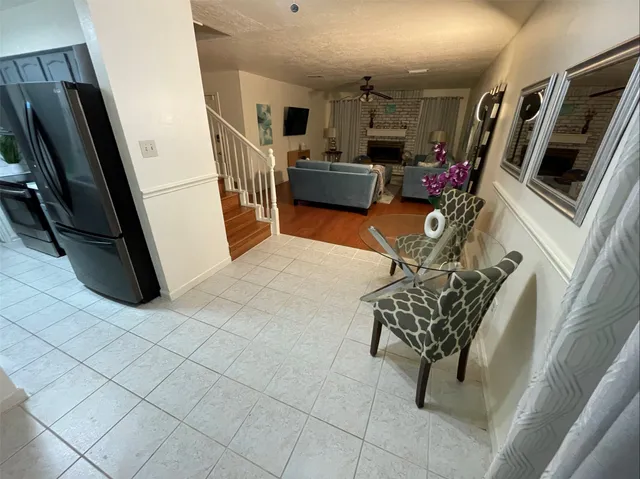a view of a livingroom with furniture and a ceiling fan