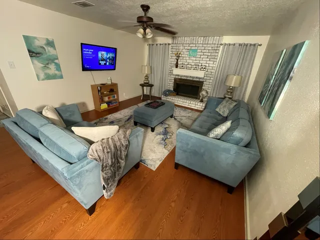 a living room with furniture and a fireplace