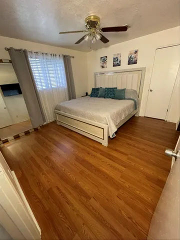 a bedroom with a bed and a chandelier