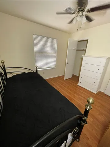 a bed sitting in a bedroom next to a window